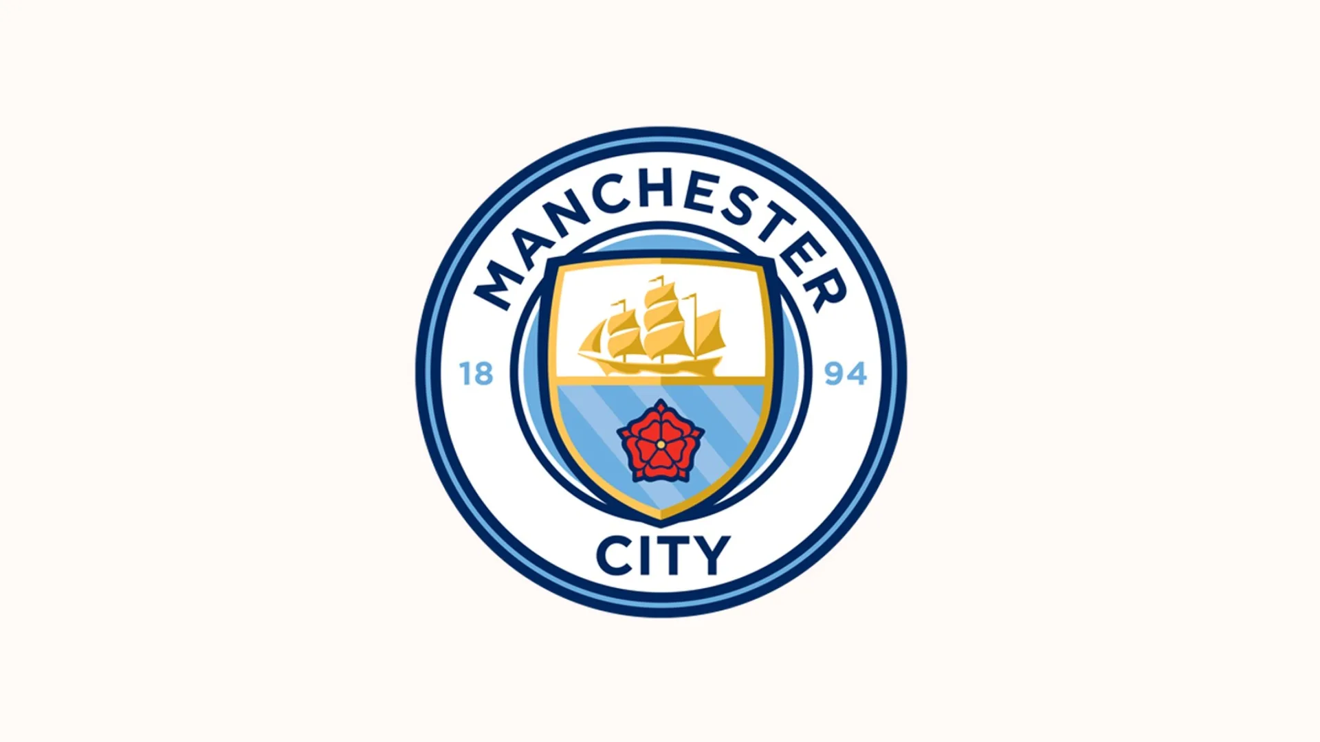 Mavi-beyaz yuvarlak Manchester City arması, ortasında gemi ve kırmızı gül.