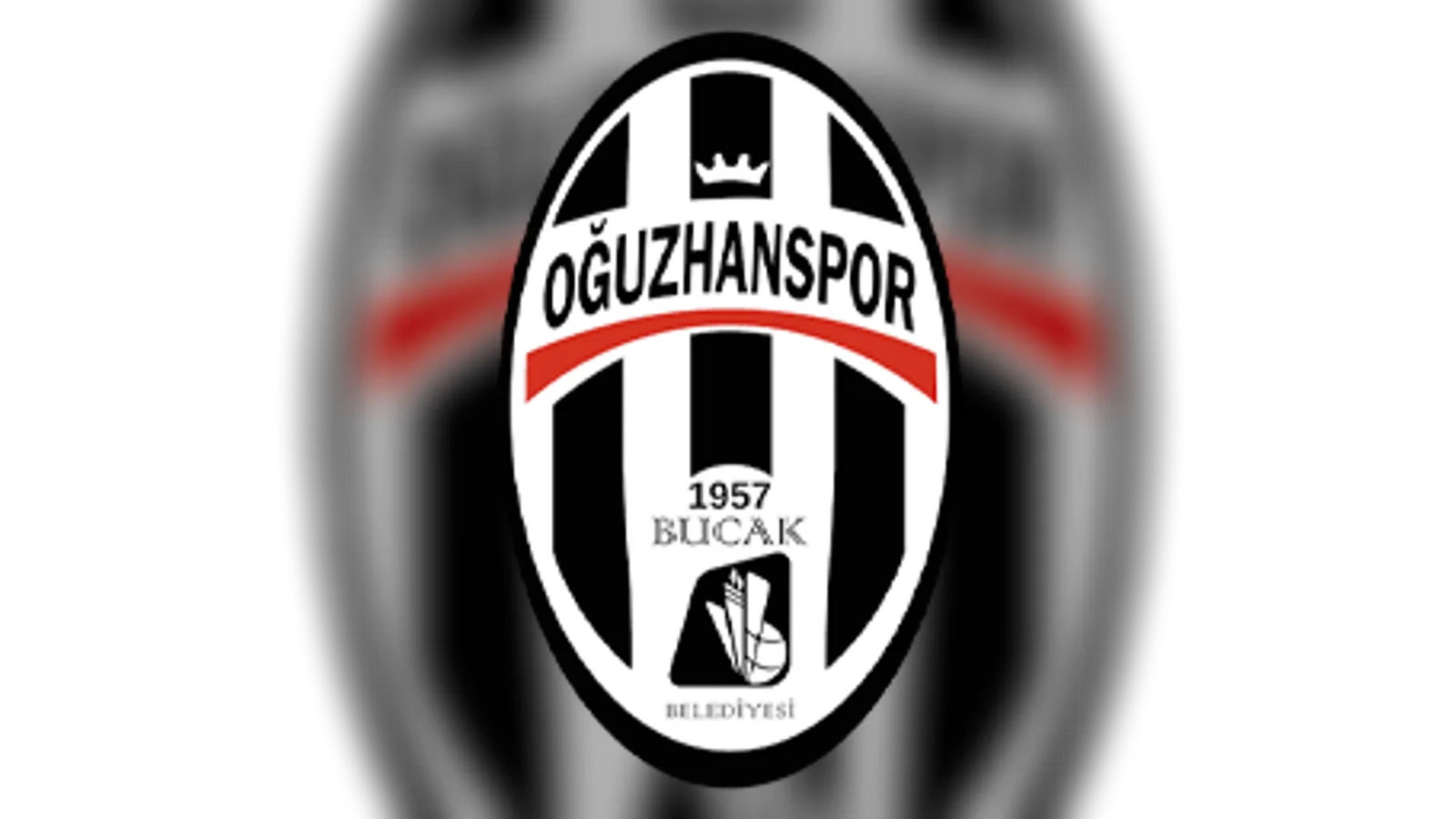 Oğuzhanspor kulüp logosu: siyah beyaz dikey çizgili oval, kırmızı şerit, 1957 Bucak yazısı.