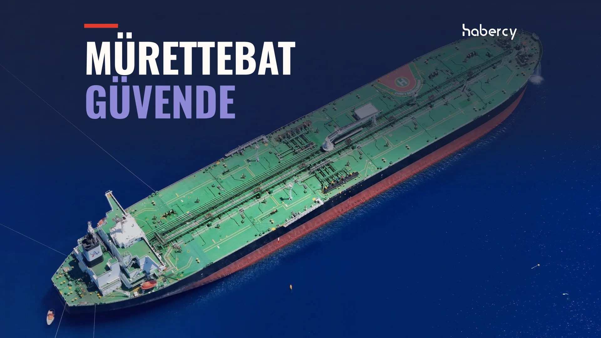 Açık mavi denizde yeşil güverteli büyük bir ham petrol tankerinin havadan görünümü